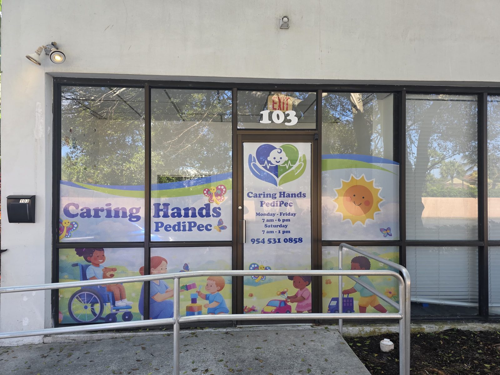 Caring Hands PediPec entrance, Suite 103, with colorful window graphics
